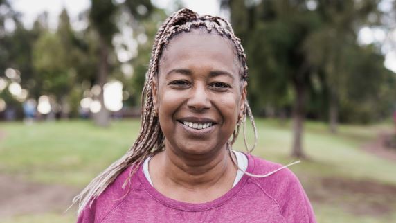 Lady in park smiling at camera